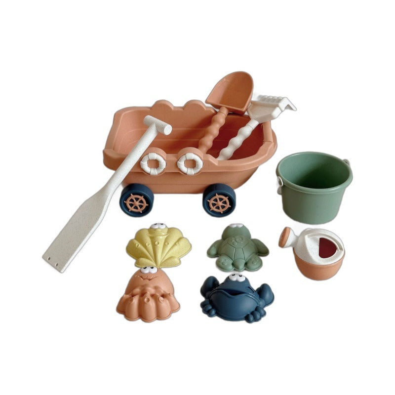 Set of beach toys including a sandcastle mold, shovel, bucket, and animal figures on a white background.
