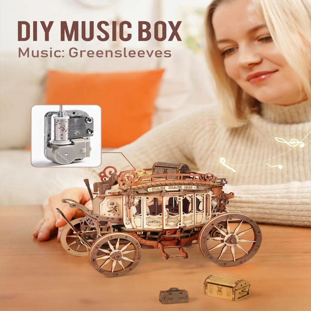 Woman holding a DIY music box with 'Greensleeves' music, sitting on a couch.