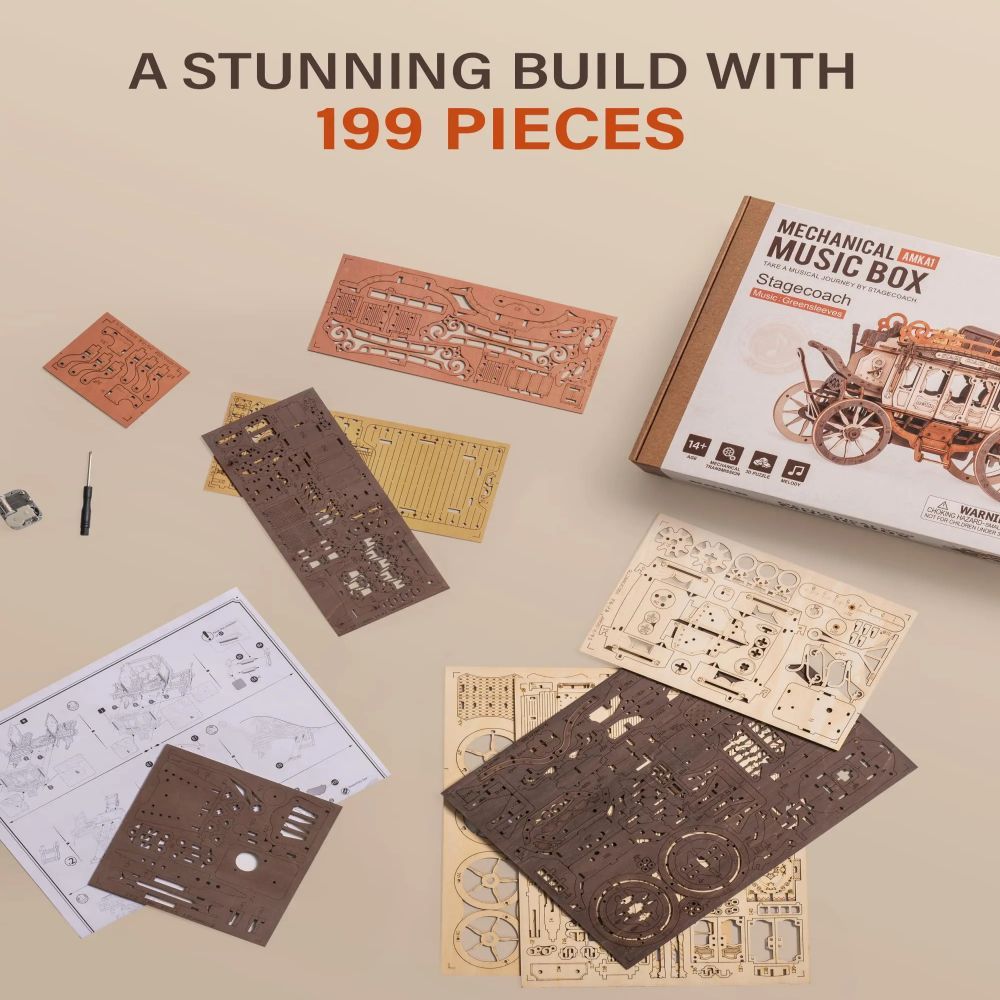 Mechanical music box building set with pieces and instructions on a beige background
